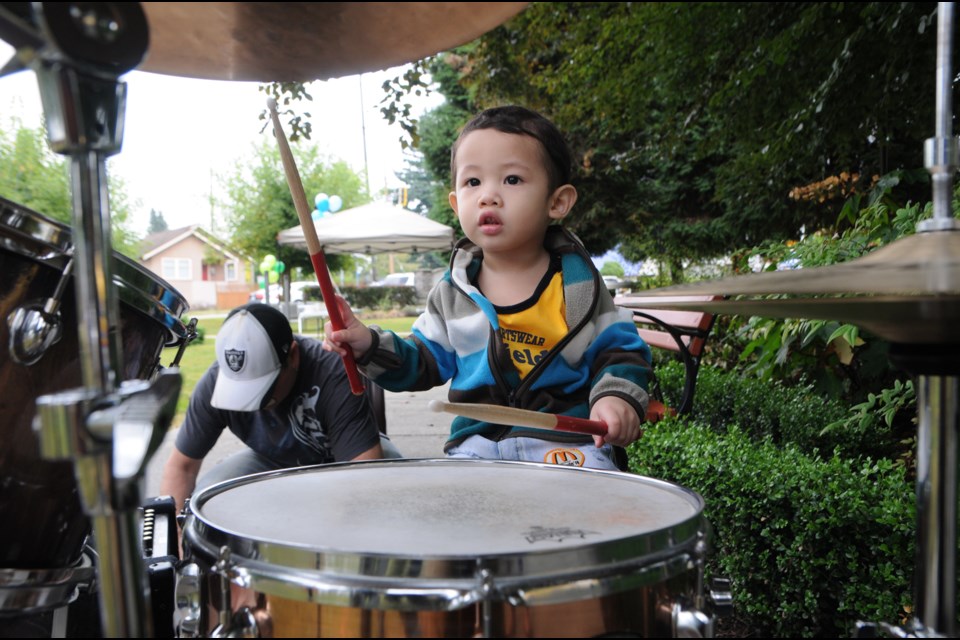 One-and-a-half-year-old Ezekiel Alviar drums his own beat at the Royal City Community Church Last Blast of Summer fair on Saturday.