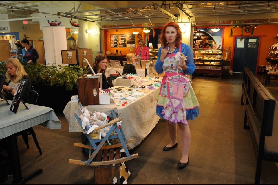 Marie West from For the Love of... checks out other tables at the New West Craft market.