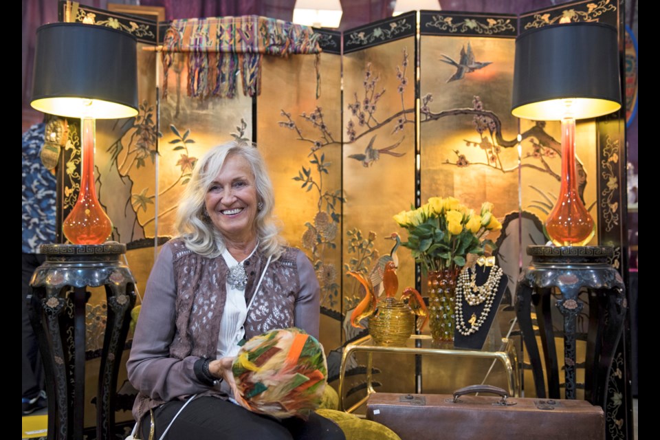 Art appraiser and former store owner Eva Garthus shows off a vintage Christian Dior hat at the 15th annual Kerrisdale Antiques Fair at Kerrisdale Cyclone Taylor Arena this past weekend.