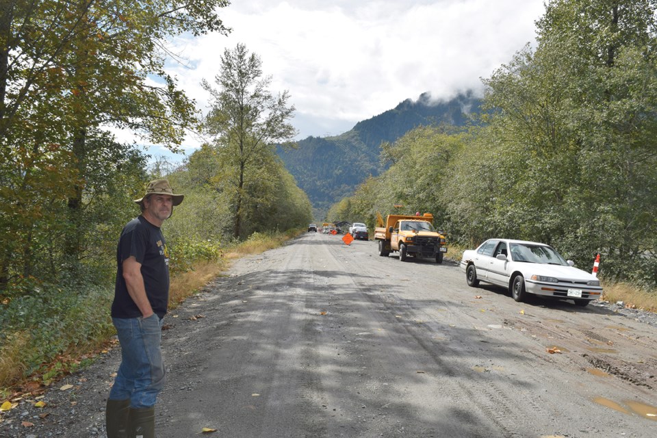 John Buchanan watching District of Squamish crews on the road to the Spit. He argues the structure should be removed to help fish populations.