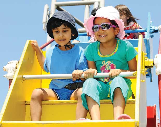 Saajn Mann, 3, and his six-year-old sister Jaya enjoy the ferris wheel.