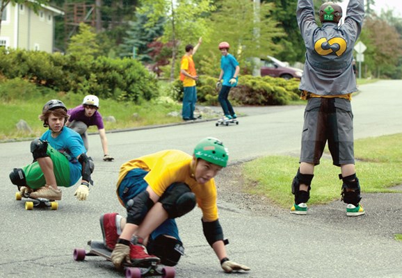 Kids participating in the Colabo School of Riding in South Surrey last summer practised safe longboarding, learning how to stop and spot for each other.