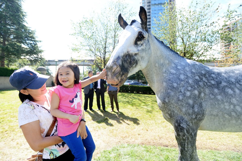 Five-year-old Isabel Sejas, with Vilma Sanic, checks out Evangeline.