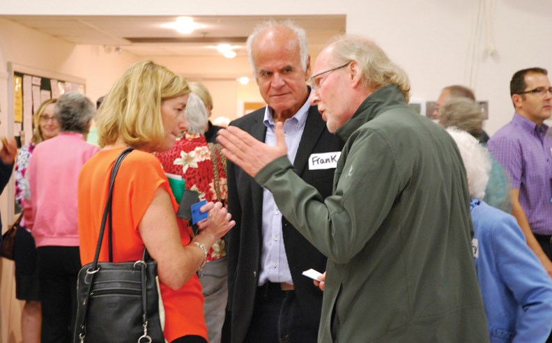 From left: VCH’s Mary Akenhusen, Regional Hospital District chair Frank Mauro, and Sechelt Mayor Bruce Milne in an animated conversation after Monday’s community meeting.