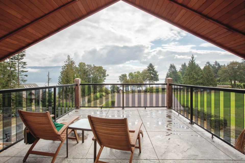 A large deck off the third-floor master bedroom overlooks the waterfront property and the smaller house down by the water, where Kmit&rsquo;s 89-year-old mother lives.