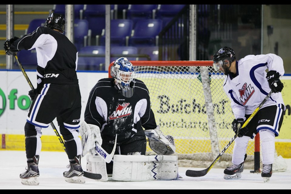 Starting goaltender Griffen Outhouse fields shots from Royals players during a practice Friday morning.
