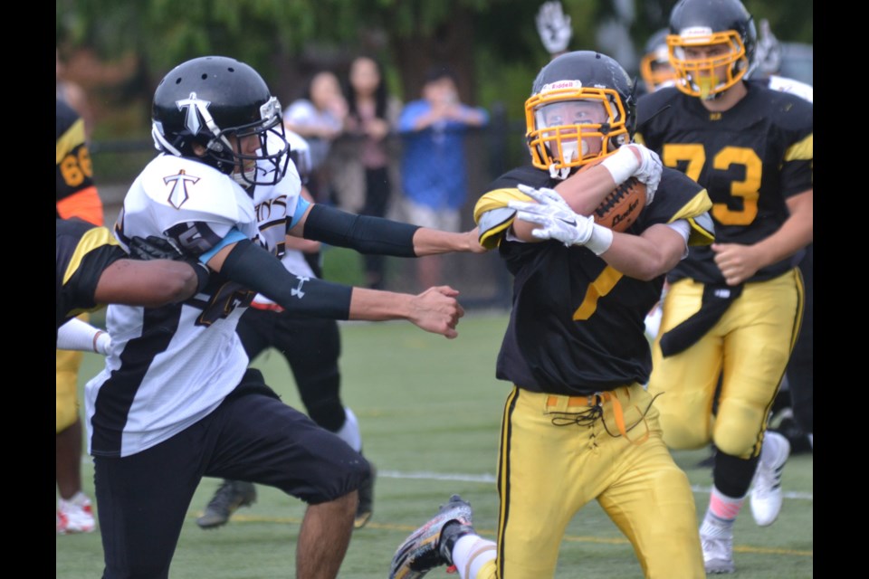 Hugh Boyd running back Reace Mok pulls away from a South Kamloops opponent in his team's 40-7 home field victory last Friday.