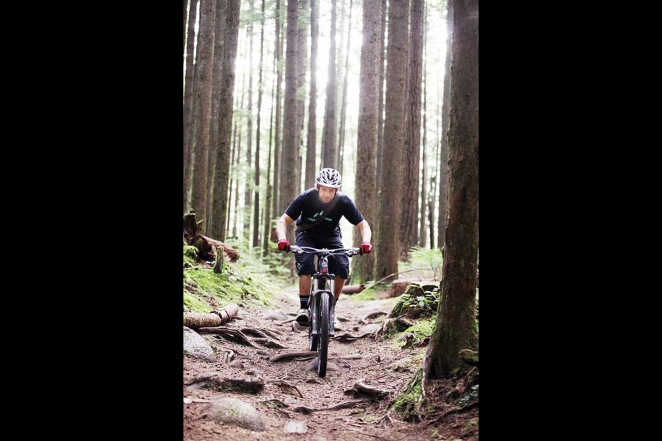 Professional mountain biker Wade Simmons rides a section of the John Thompson trail in the Lower Seymour Conservation Reserve that Rocky Mountain Bicycles is maintaining under the North Shore Mountain Biking Association's new Trail Adoption Plan. The project seeks out sponsors to help breathe new life into North Vancouver's ailing trails.