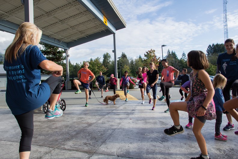 Colleen Preston led the Gibsons runners in some pre-run warm-up stretches. A little over 100 people raised $2,550 in the Gibsons Terry Fox Run; this was matched by volunteer organizers Mary Findlay and Donald Bland.