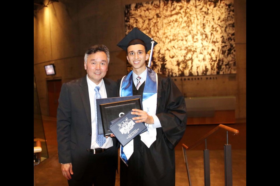 Alon Aminov with McMath principal Neil Kamide at last June’s graduation, where Aminov was valedictorian and received a $2,500 scholarship from Coast Capital Credit Union for overcoming adversity.