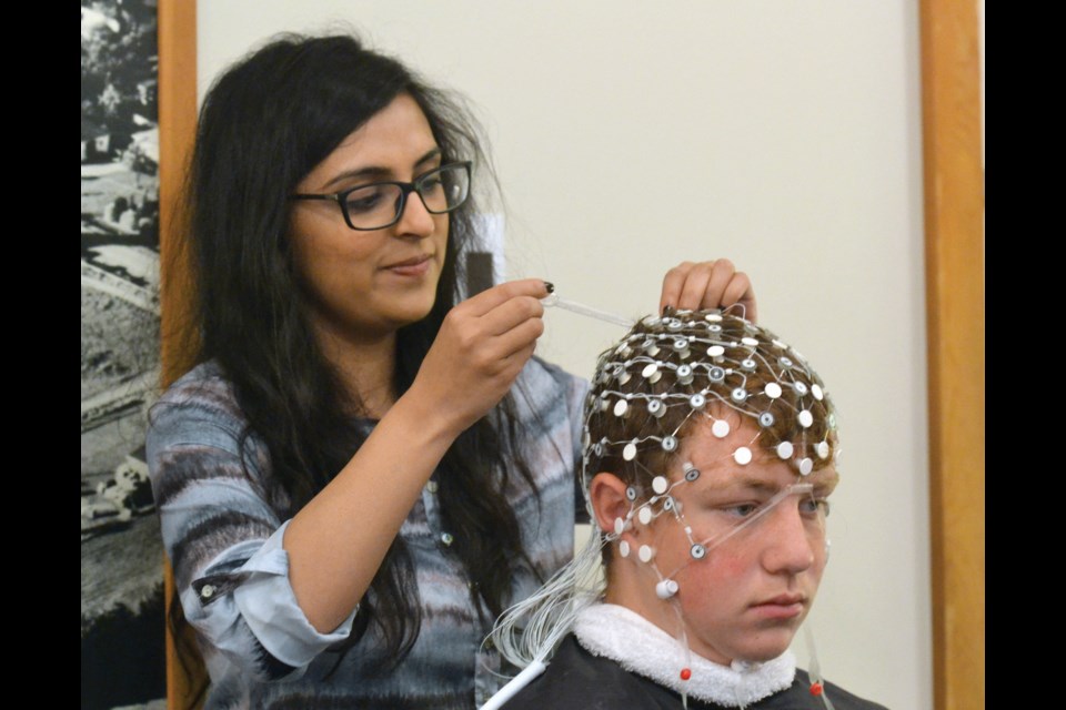 Amna Hyder prepares Richmond FC player Blake Charlesworth for an EEG scan as part of the club’s baseline testing session last weekend at Brighouse Park. The youth soccer association has teamed up with UBC for the leading edge project.