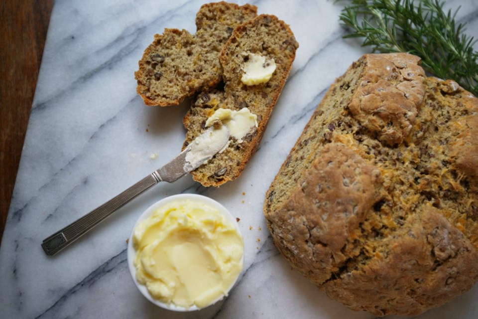 Dense, savoury soda bread is strewn with wheat berries, cheese, nuts and rosemary.