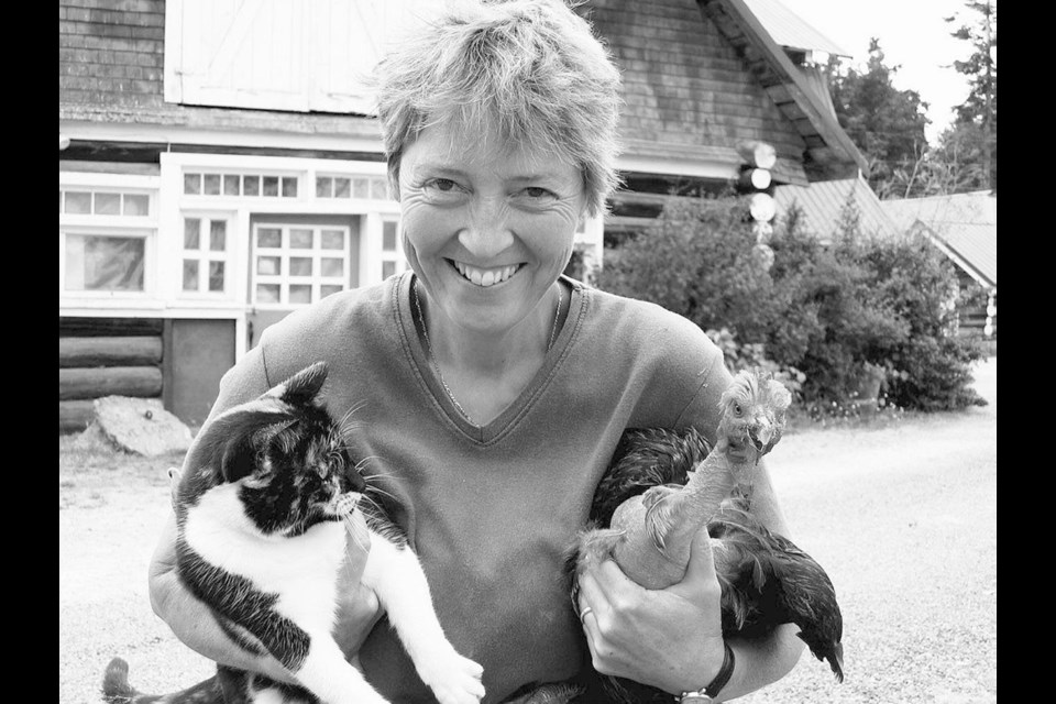 Victoria author Anny Scoones with her cat Annabelle and naked-neck chicken Olga.