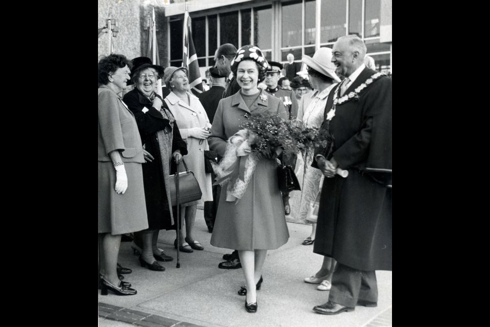 The Queen strolls through Centennial Square escorted by Mayor Courtney Haddock during her 1971 visit to Victoria.