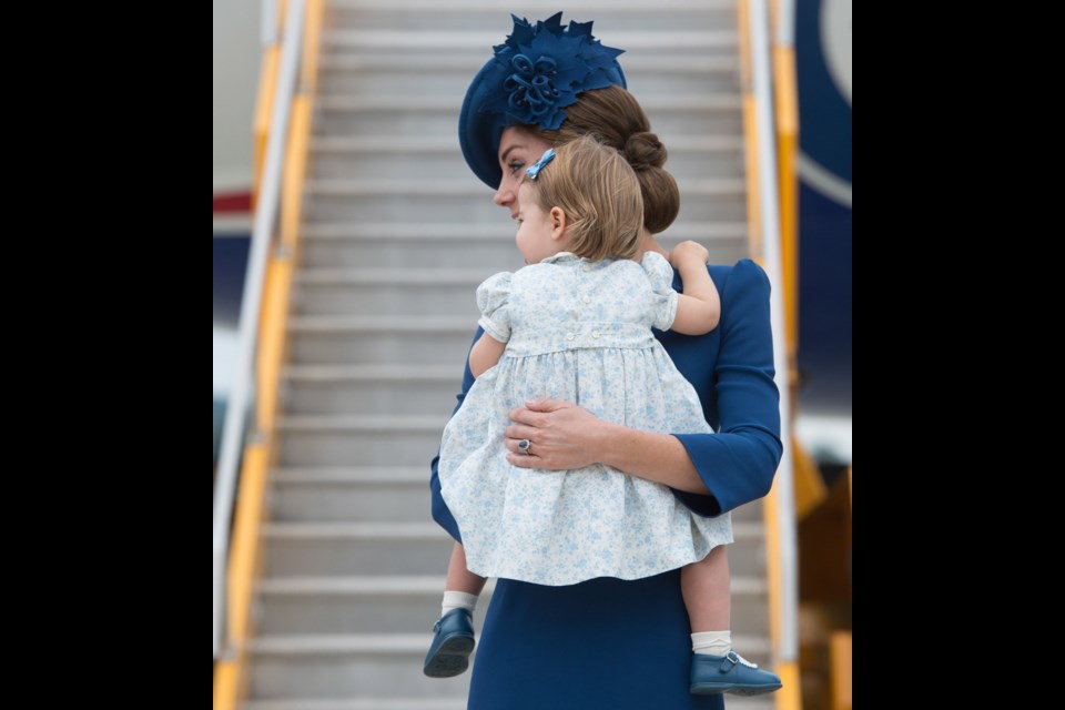 The Duchess of Cambridge holds her daughter Princess Charlotte as the family arrives in Victoria, B.C., on Saturday, September 24, 2016.