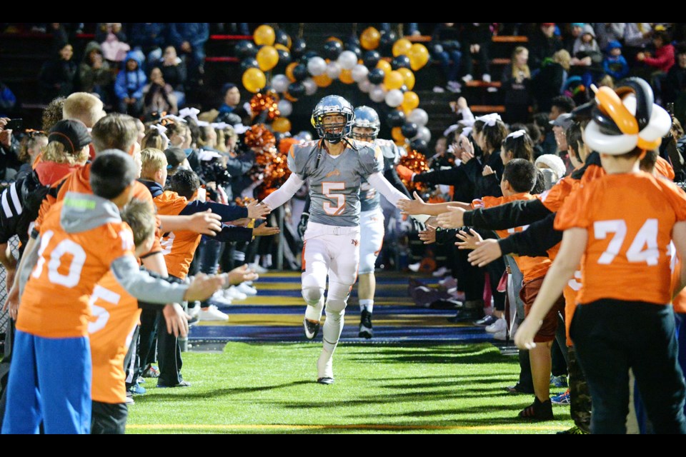 New Westminster's Broxx Comia emerges from the dressing room to a great reception as more than 1,500 fans braved the rain to cheer on the host Hyacks at the annual Homecoming Game.