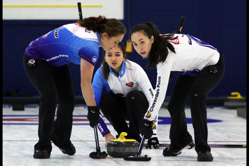 Members of the Royal City/Delta curling Daniels team, from left, Sydney Brilz, Sarah Daniels and Megan Daniels, play the rock during the junior women's final at the Anita Cochrane Memorial Junior Classic in New Westminster.