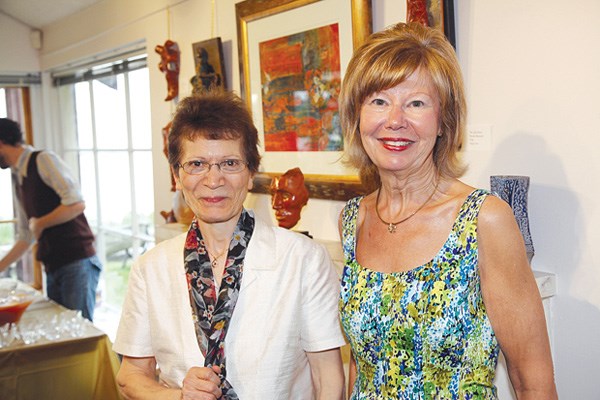 Exhibiting artists Roohy Marandi and Sharon Mason greet guests.