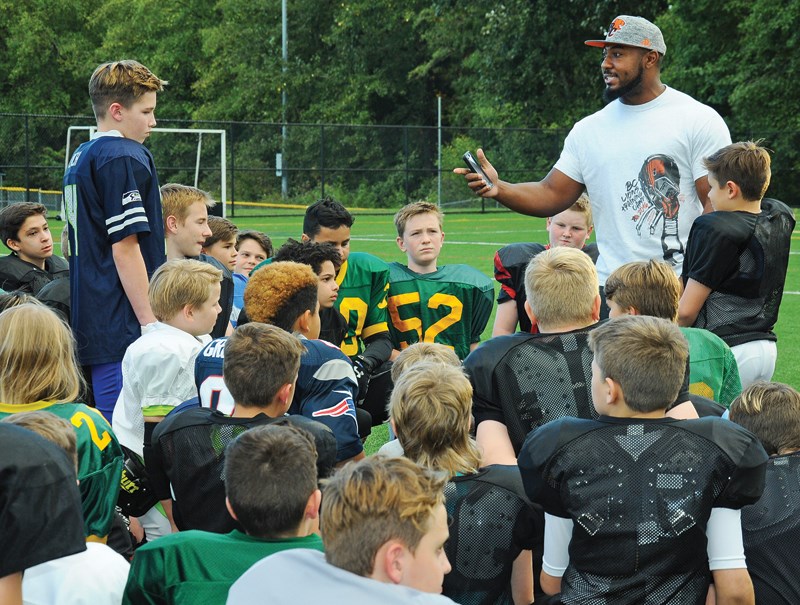 Bryant Turner of the BC Lions shares an anti-bullying message with members of the GSL North Shore Football League before their annual Pass, Punt and Kick competition held Sept. 20 at Carson Graham’s Confederation Field. photo by Cindy Goodman, North Shore News
