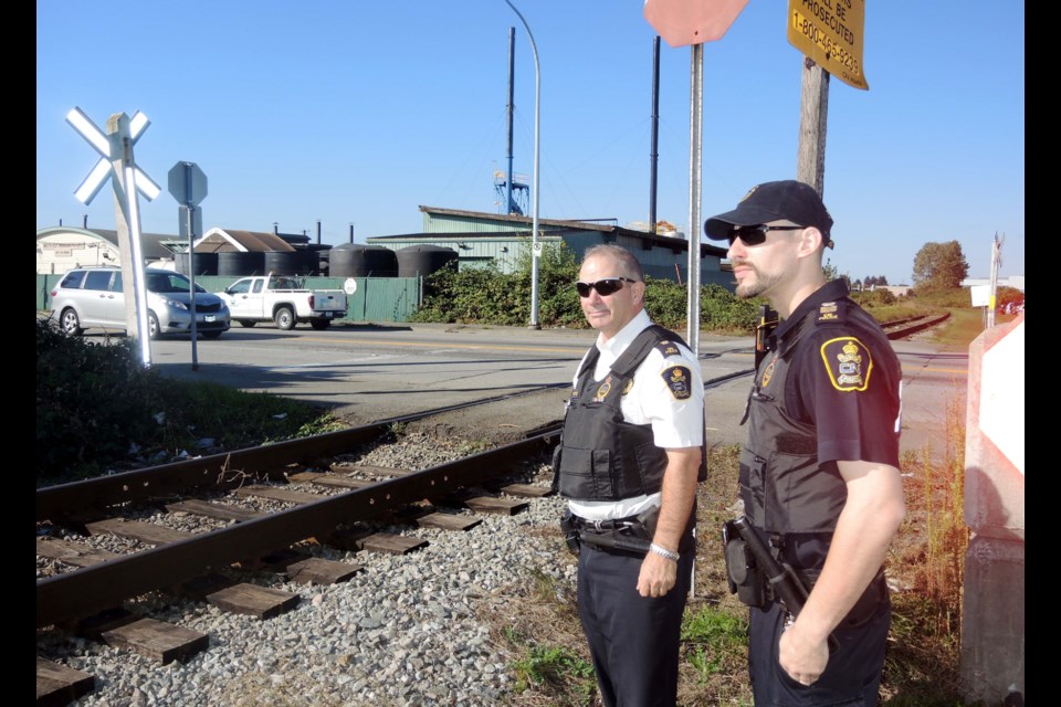 As part of the first-ever Canada/USA Railway Crossing Enforcement Day, Insp. Dan Ritchie, left, and Sgt. Andrew Spanos, of the CN Police, targeted the crossing on No. 5 Road near Vulcan Way last week to catch drivers ignoring the stop signs.