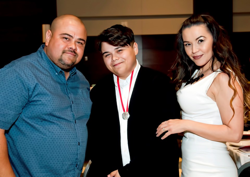 Isaiah Lehtinen with his parents, Darcy and Shauntele, at his graduation in June. Photo Chung Chow