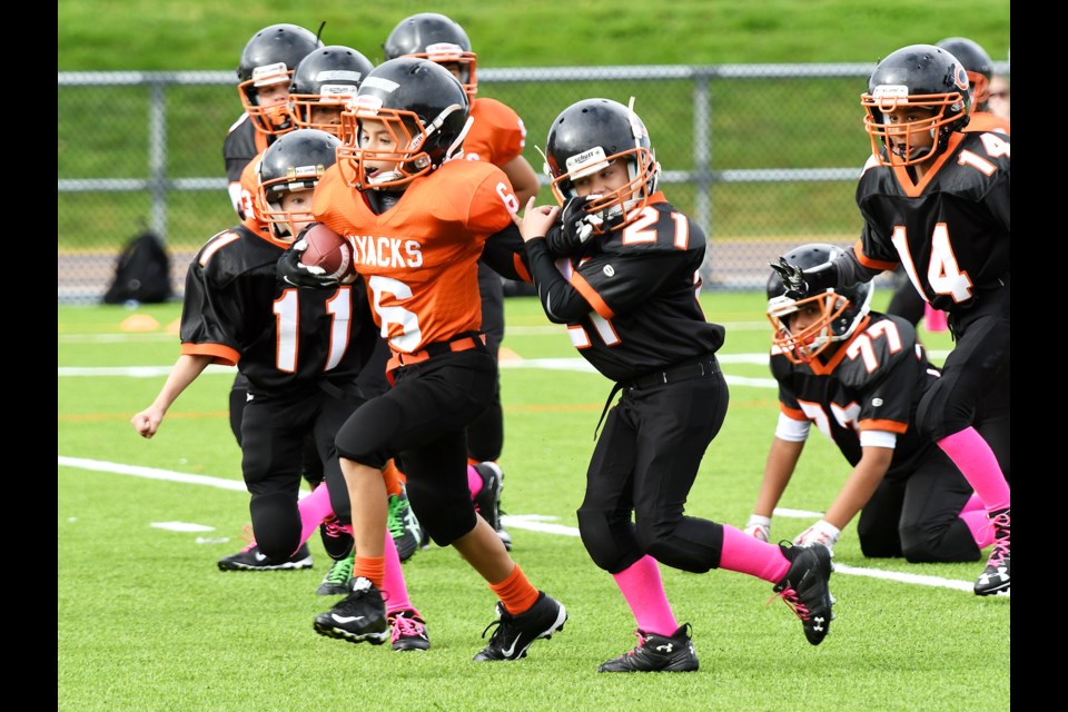 Royal City Hyacks’ Benicio Hageleit aims to scramble past a Cloverdale tackler during Sunday’s atom division match-up at Mercer Stadium. Despite a standout effort from defender Nathan Hillmann, Royal City fell 28-0. Hillman recorded two forced fumbles and a pair of fumble recoveries on the day, while the secondary of Jake Gardiner, Nikolas Panesar and Noah Thiessen continue to make strides on the defensive side.