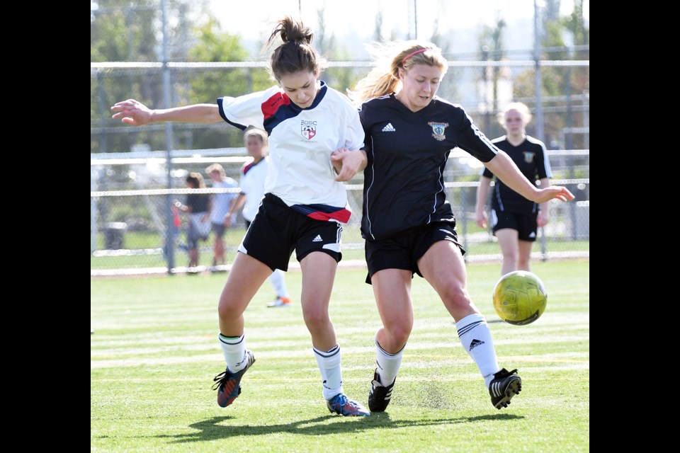 Defender Daniella Trevisan, left, battles a rival for the ball during a recent Burnaby Canadians soccer game. The team currently sits tied for second place in the Metro Women's select B division.