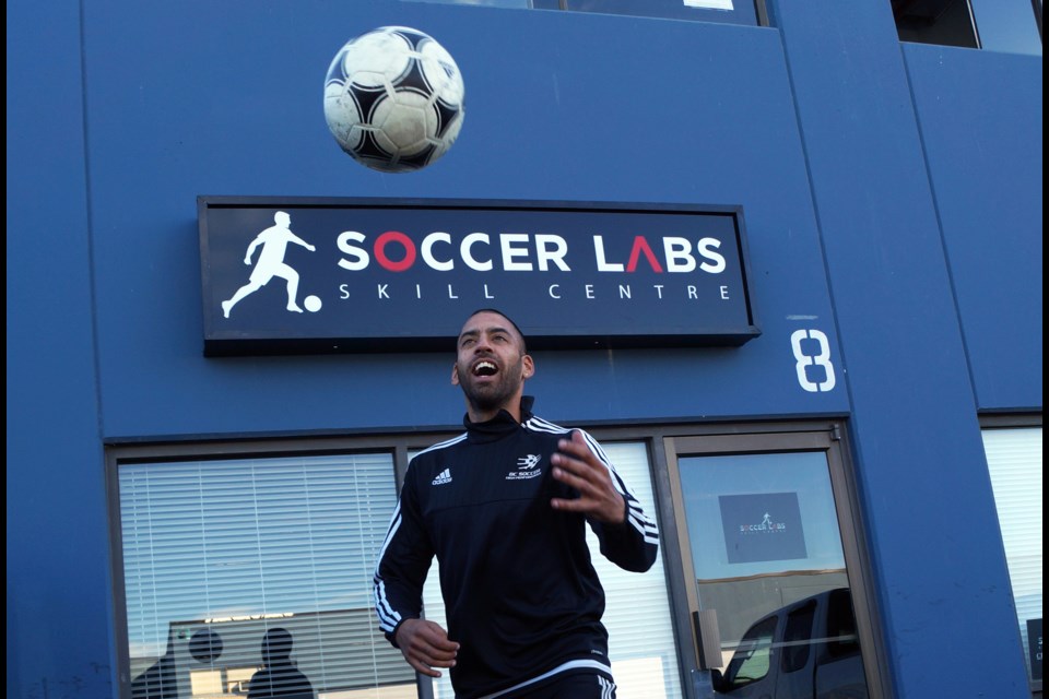 Soccer coach-turned-soccer teacher Daryl Ware-Lane has opened a new skills academy for one-on-one development. The Arsenal fan juggles a ball outside the newly-opened facility in Steveston on No. 2 Road. Photo by Graeme Wood/Richmond News.