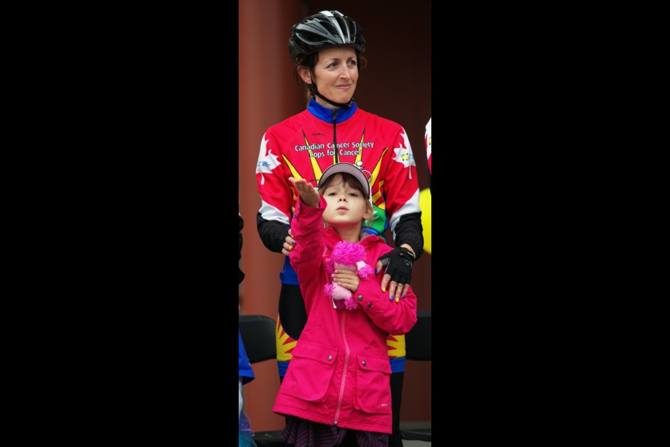 Melia Balze, 7, blows a kiss to the crowd in front of her rider, Mena Westhaver, at the Tour de Rock finale at Centennial Square on Friday. In 2013, Melia was diagnosed with Wilms' tumour, a rare form of kidney cancer. Westhaver's 13-year-old son, Jack, was diagnosed with leukemia in 2009. "Cancer has taught me that you can't get through life's struggles alone" Westhaver told the crowd.
