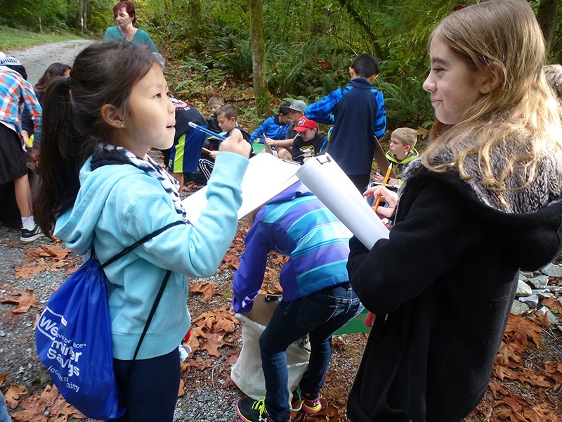 Pleasantside elementary school students share notes during a field trip to Mossom Creek Hatchery.