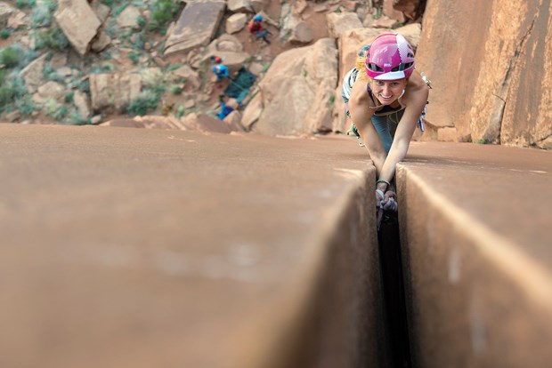 Brette Harrington climbing a wide crack at the Canyonlands in Indian Creek, Moab, Utah.