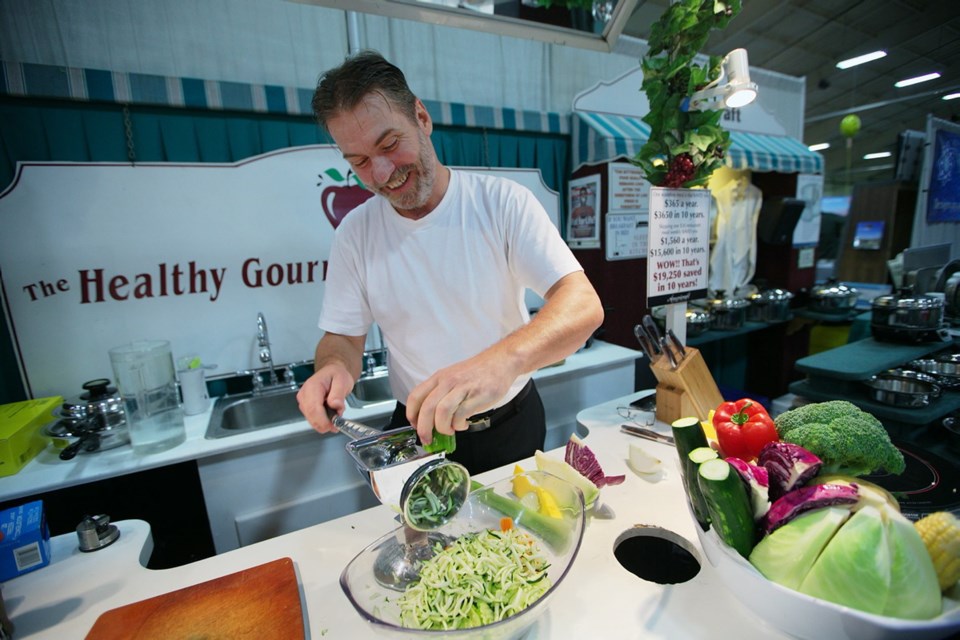Van Gauthier chops vegetables at the Kitchen Craft Cookware booth at the 31st annual Fall Home Expo.