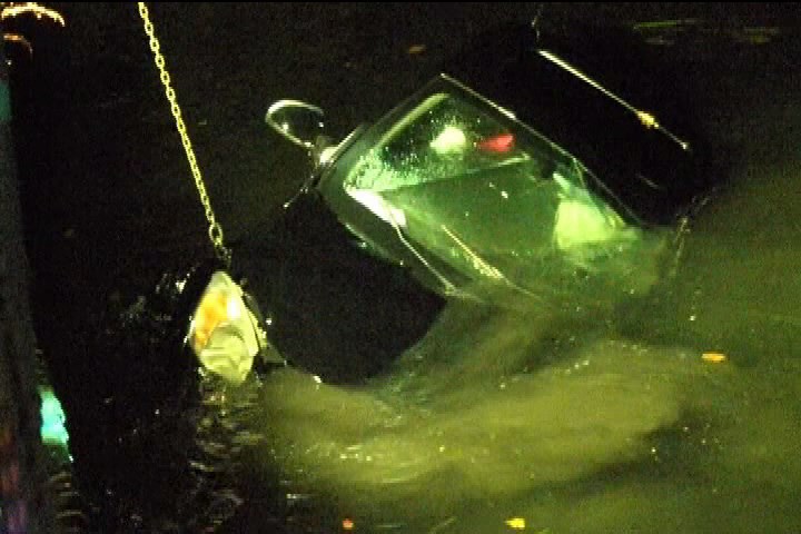 A car is pulled from the Gorge Waterway after a speeding motorist drove into the water late Saturday.