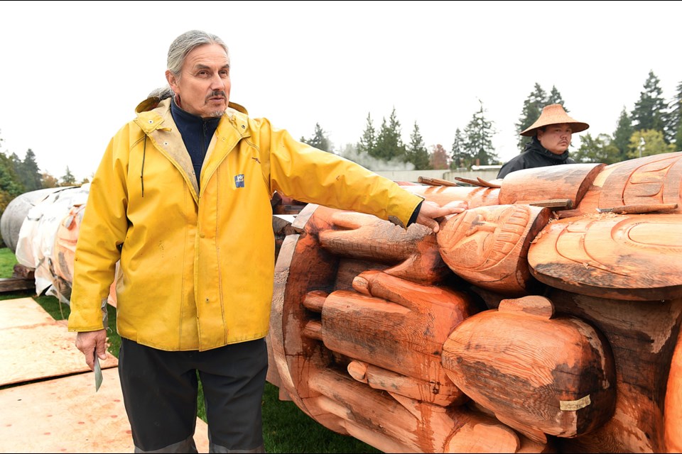 Haida artist James Hart with the Reconciliation Pole on the grounds of the University of B.C. in 2016. Photo Dan Toulgoet