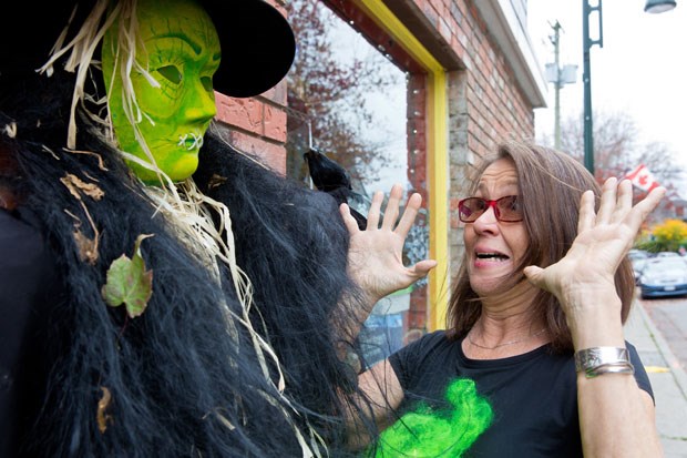 Angela Husvik of Angela's Boutique gets a "scare" from a scarecrow in Ladner Village.