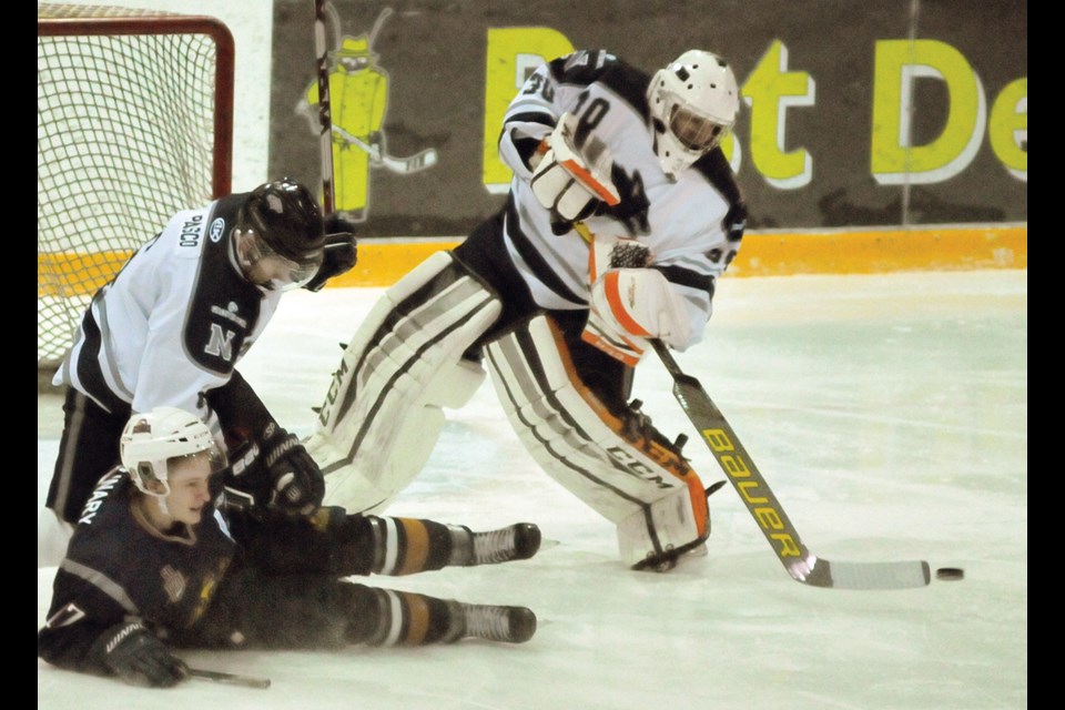 Goaltender Trevor Withers makes a play under pressure during a PJHL game with the North Van Wolf Pack last season. Withers started this year in the Northern Ontario Junior Hockey League but is back with the Pack now as their No. 1 option in goal. photo by Paul McGrath, North Shore News
