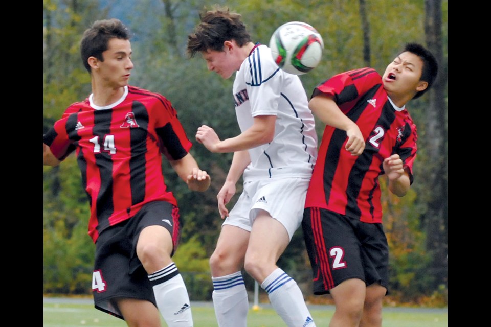 Sutherland’s Alec Wilson squeezes between a pair of St. Thomas Aquinas defenders during a North Shore senior boys AA matchup Oct. 13. Sutherland scored a 2-1 win to stay near the top of the league standings. photo by Paul McGrath, North Shore News