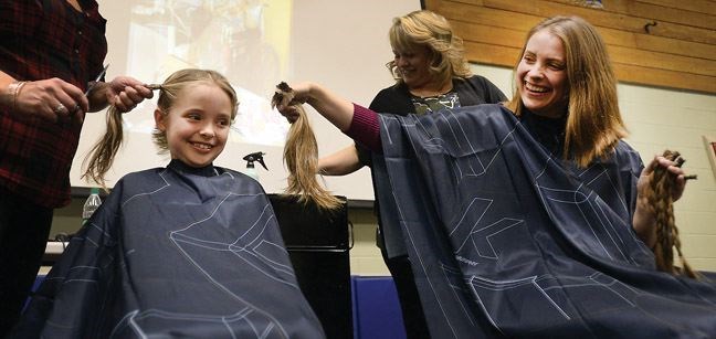 Calista Frost, 7, and her mom Amanda Frost have their hair cut off at Heritage elementary school on Friday afternoon. Calistas sister Olivia is in B.C. Childrens Hospital fighting cancer. The school raised more than $6,200 for cancer research.
