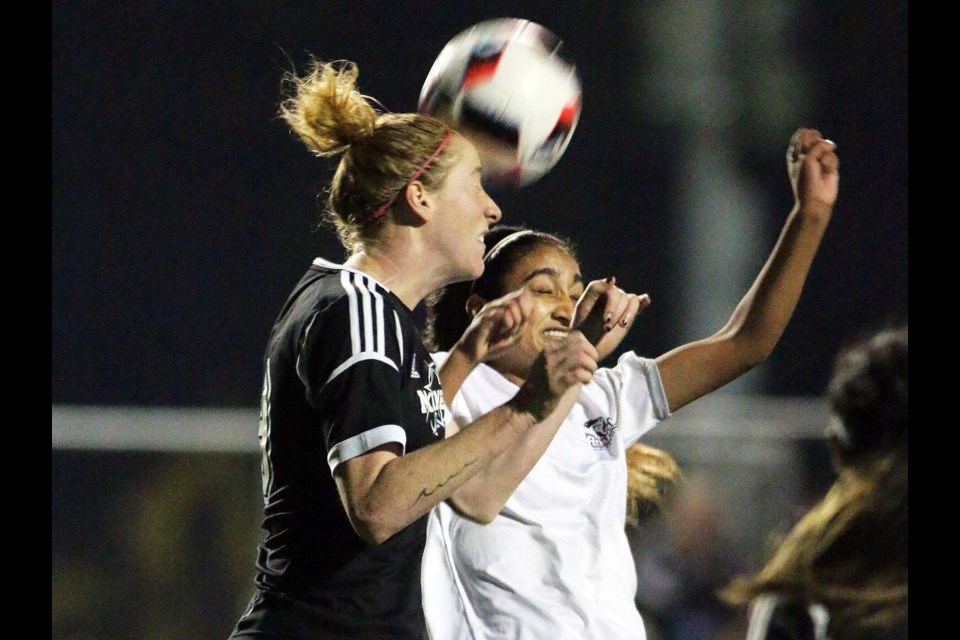 Douglas College's Nisha Simra, at right, battles a VIU opponent for the ball during last week's PacWest women's soccer championship in Burnaby.