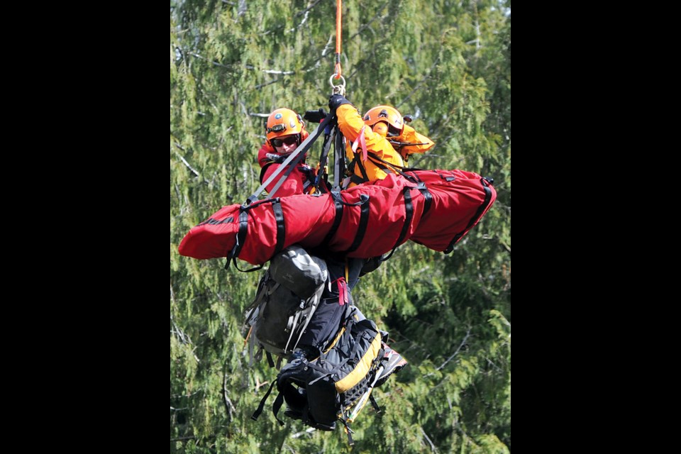 North Shore Rescue used a longline rescue technique to evacuate a tourist who fell 30 metres off a snowy trail near Lions Bay Sunday. The team had been practicing the rescue technique Saturday in a rescue drill (above) in the Lower Seymour Conservation Reserve.