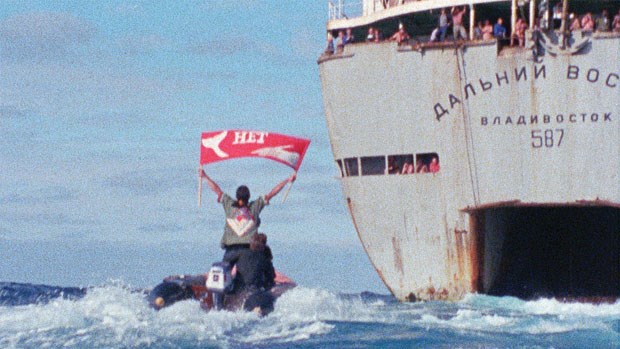 Greenpeace crew member Rex Weyler holds up a sign reading ‘No’ (in Cyrillic Russian) as his Zodiac speeds towards the Dalniy Vostok, the mother ship of the Soviet whaling fleet. Weyler took a leave of absence from his editorial duties at the North Shore News to be a part of the campaign.