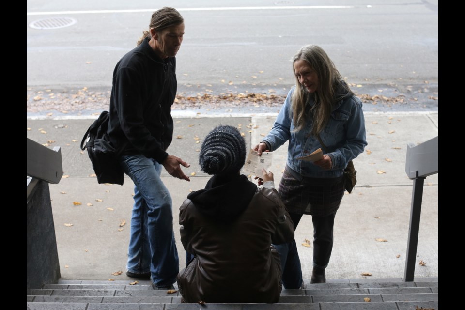 Street outreach volunteers Michael Peck and Karen Wilkinson hand out leaflets with information on the latest drug dangers.