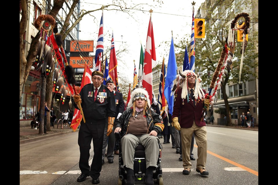 The National Aboriginal Veterans Day ceremony took place at Victory Square Tuesday. Allen Derouin (left) with Veteran's eagle staff, Bob Kelly, and Old Hands, with his eagle staff. photo Dan Toulgoet