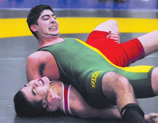Windsor Grade 11 student Alberto Flores pins his Vancouver College opponent at the wrestling zone qualifiers held Feb. 10 at Balmoral.