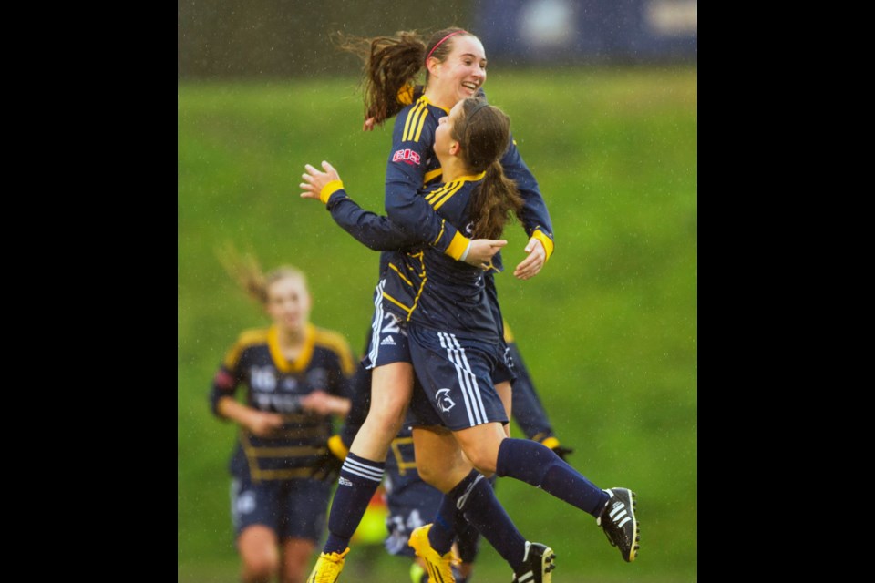 Trinity Western University’s Isabella Di Trocchio, centre, celebrates with a teammate after scoring in penalty kicks at last year’s Canadian Interuniversity Sports (now U Sports) soccer championships in Vancouver.