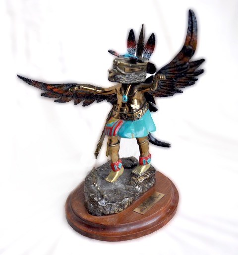 Brass eagle dancer with removable mask, up for auction along with more than 300 other items.