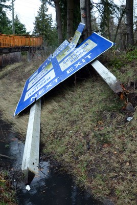 A large sign on Hwy #1 at the pedestrian overpass just east of the Capilano exit was knocked over by heavy wind Monday morning.