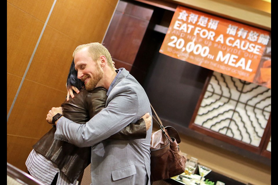 Elaine Cheng, whose family owns Fortune House Seafood Restaurant in Burnaby, and Derek Juno of Mealshare embrace during a celebration last month in honour of Fortune House’s commitment to Mealshare, a Vancouver-based charity that helps feed kids in need locally and abroad.