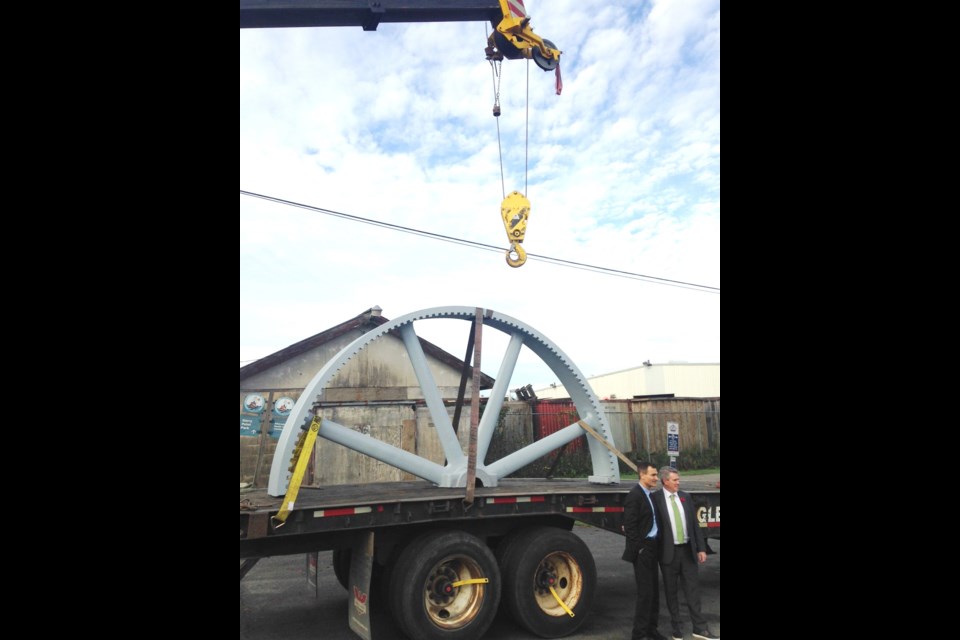 This imposing, 6,500-pound fly wheel - used as part of an industrial ice-making machine in the fishing industry between 1910 and 1970 - was restored to its former glory thanks to federal government funding for the Gulf of Georgia Cannery. Watching it being loaded on and off a truck were Steveston-Richmond East MP Joe Peschisolido (left) and Cloverdale MP John Aldag.