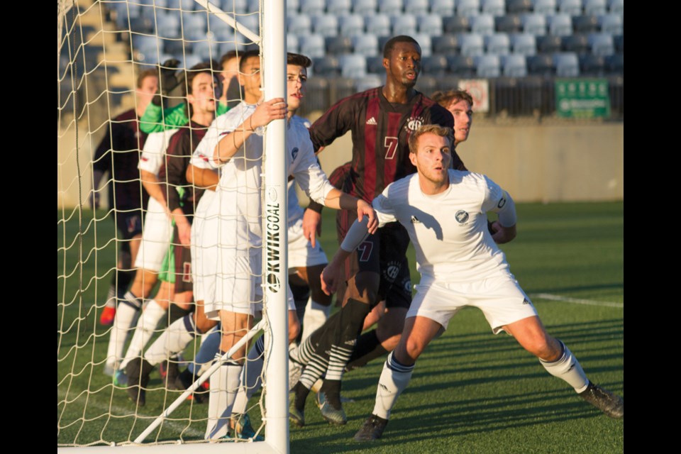 Fifth-year captain Devan Woolley (right) leads the defence for the Capilano Blues at the CCAA national championships held Nov. 9-12 in Fort McMurray. The Blues bounced back to claim bronze after losing to the host Keyano Huskies in the semifinal. photo by Robert Murray/CCAA